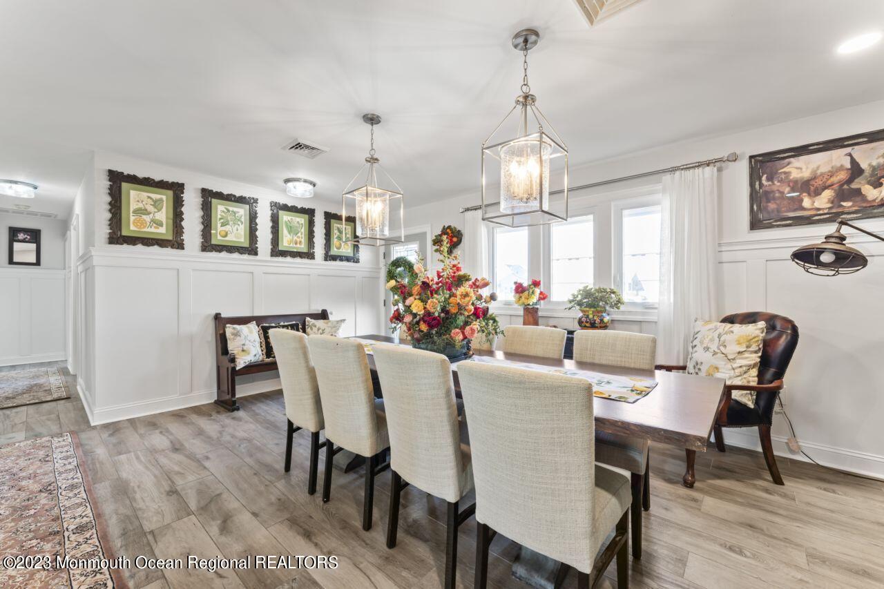 110 Stillwater Road Barnegat, NJ 08005 - Photo 9 of 35 a view of a dining room with furniture a chandelier and wooden floor