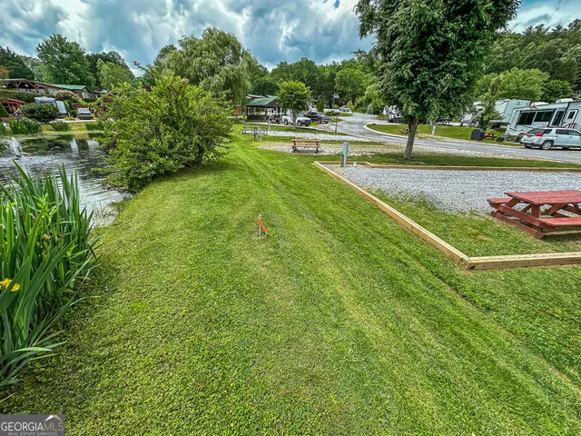 a view of a swimming pool with a yard and sitting area