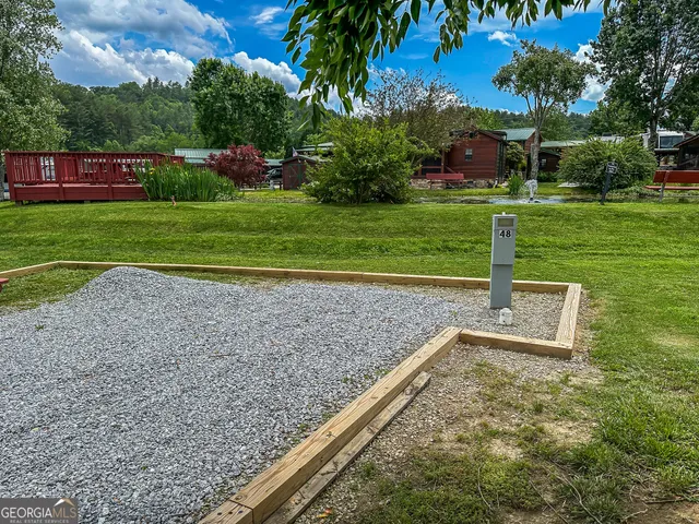 a view of a backyard with large trees