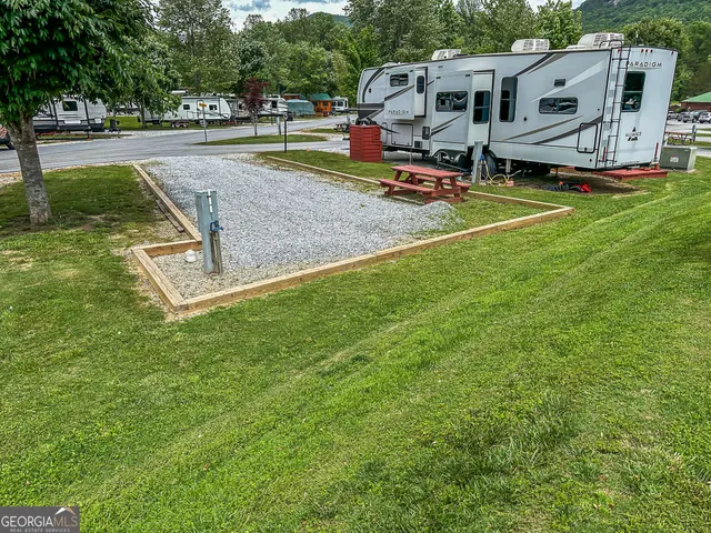 an aerial view of a house with a yard and trees
