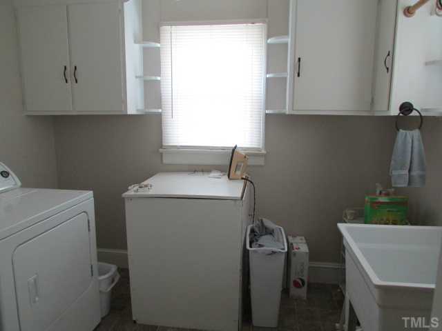 119 Gregory Street Roxboro, NC 27573 - Photo 15 of 21 Utility room is spacious and offer good cabinet storage, utility sink.