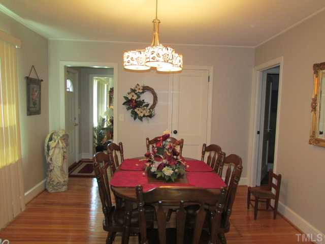 119 Gregory Street Roxboro, NC 27573 - Photo 6 of 21 Dining room is located off the foyer. The door to the right goes to the master bedroom. Look at those beautiful floors