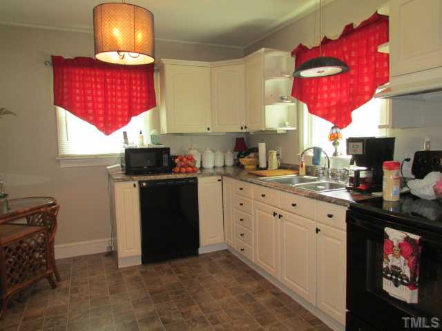 119 Gregory Street Roxboro, NC 27573 - Photo 8 of 21 Kitchen was remodeled recently with new cabinets, countertops, sink, light fixtures, appliances. Kitchen is large enough to have breakfast table in it too.