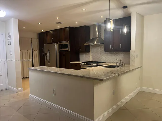 a view of a kitchen with a sink and a large window