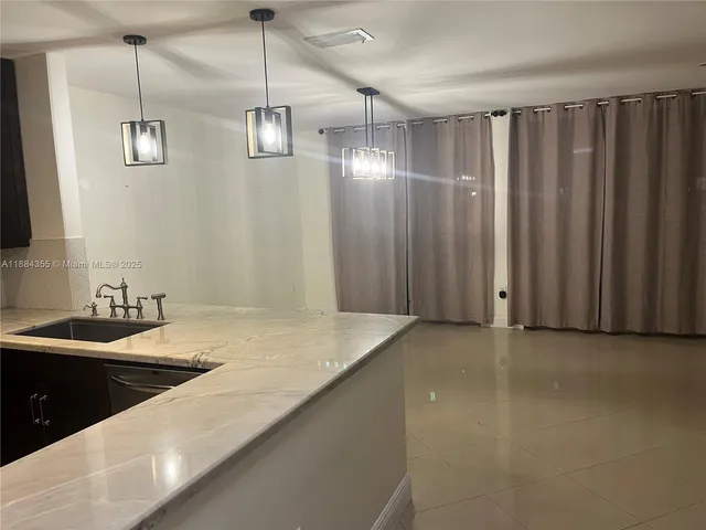 a kitchen with sink and center island