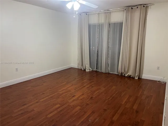 a view of a room with wooden floor