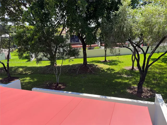a view of a park with large trees