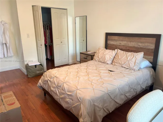 a bedroom with a bed and a mirror