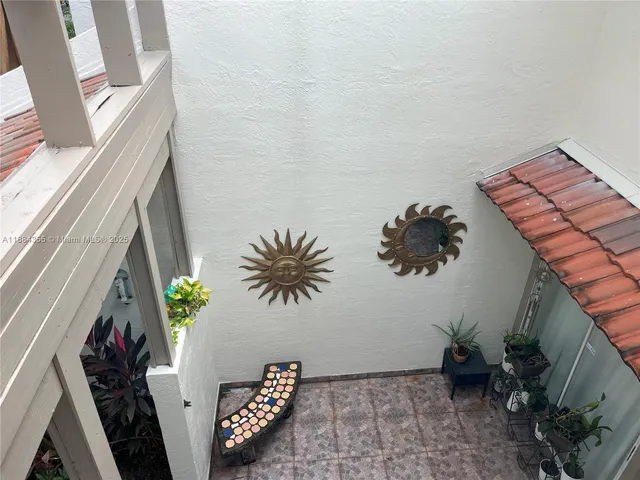 a potted plant sitting on a floor next to a pot