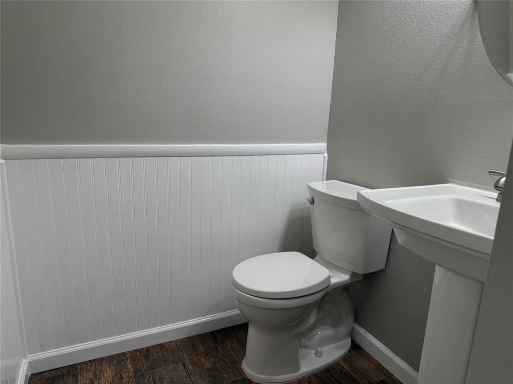 909 Carthage Way Arlington, TX 76017 - Photo 4 of 31 The half bath is nestled by the coat closet beside the stairs