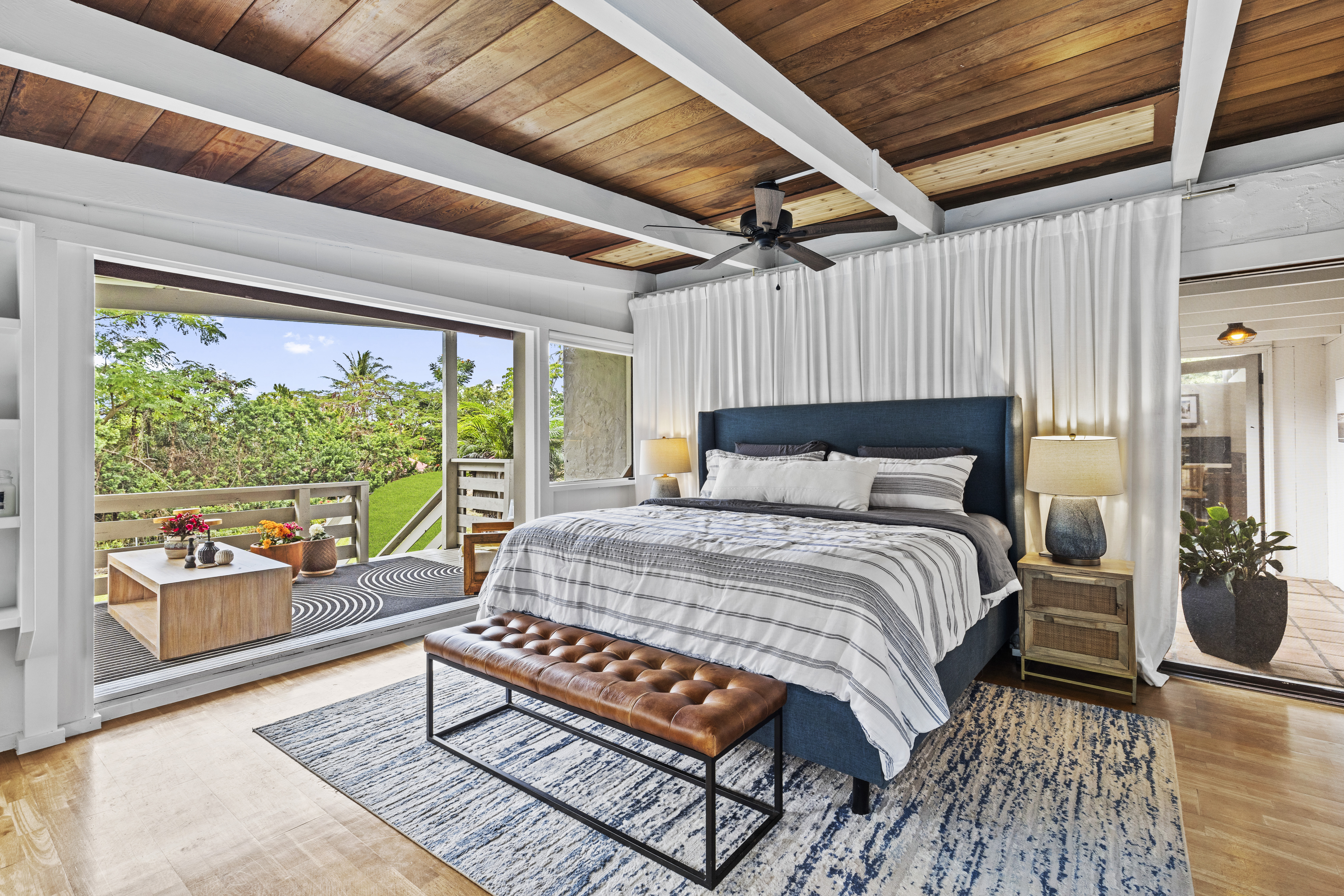 83-5369 Manako Road Captain Cook, HI 96704 - Photo 15 of 30 a bedroom with a bed and wooden floor