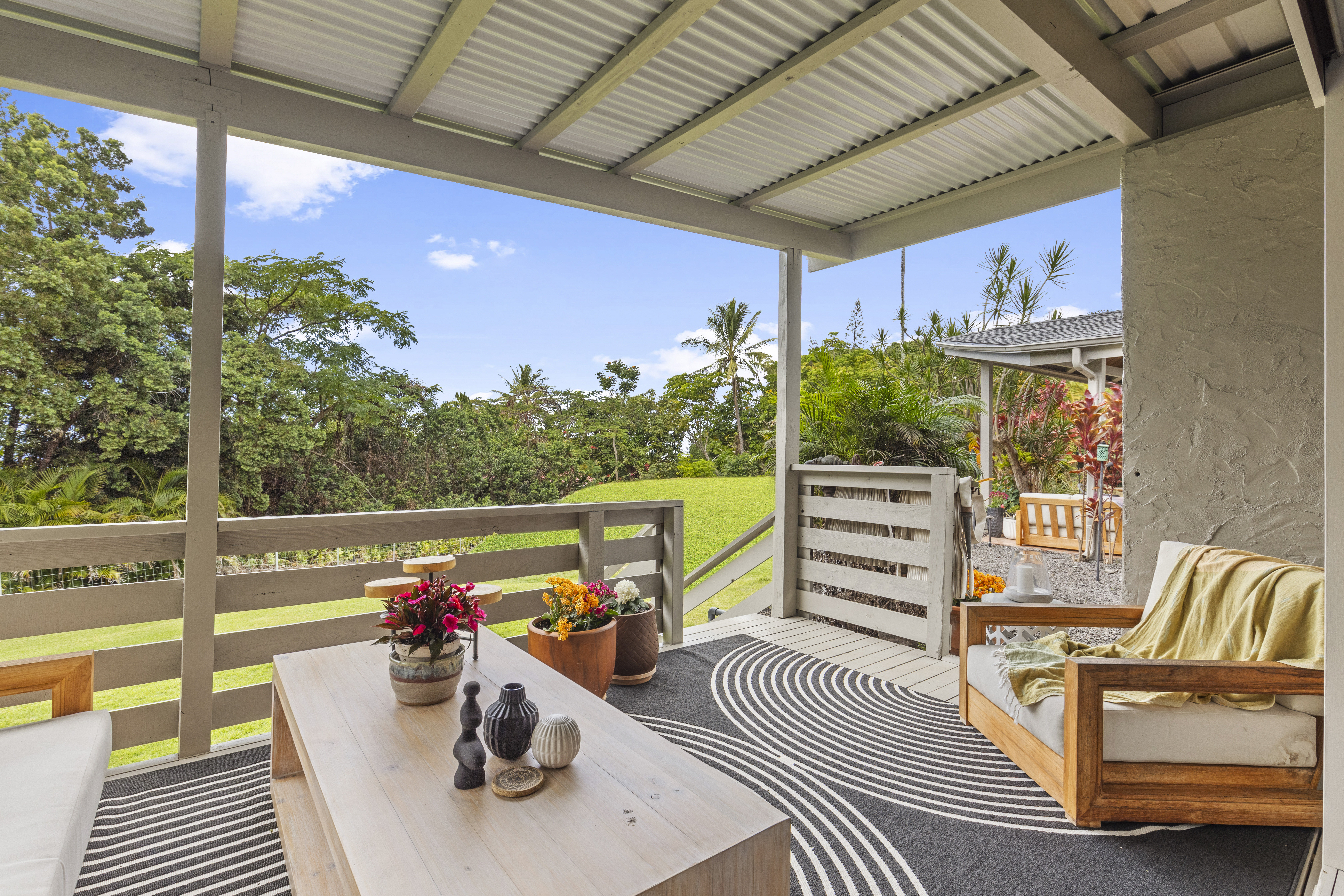 83-5369 Manako Road Captain Cook, HI 96704 - Photo 16 of 30 a view of a patio with a table chairs and a patio