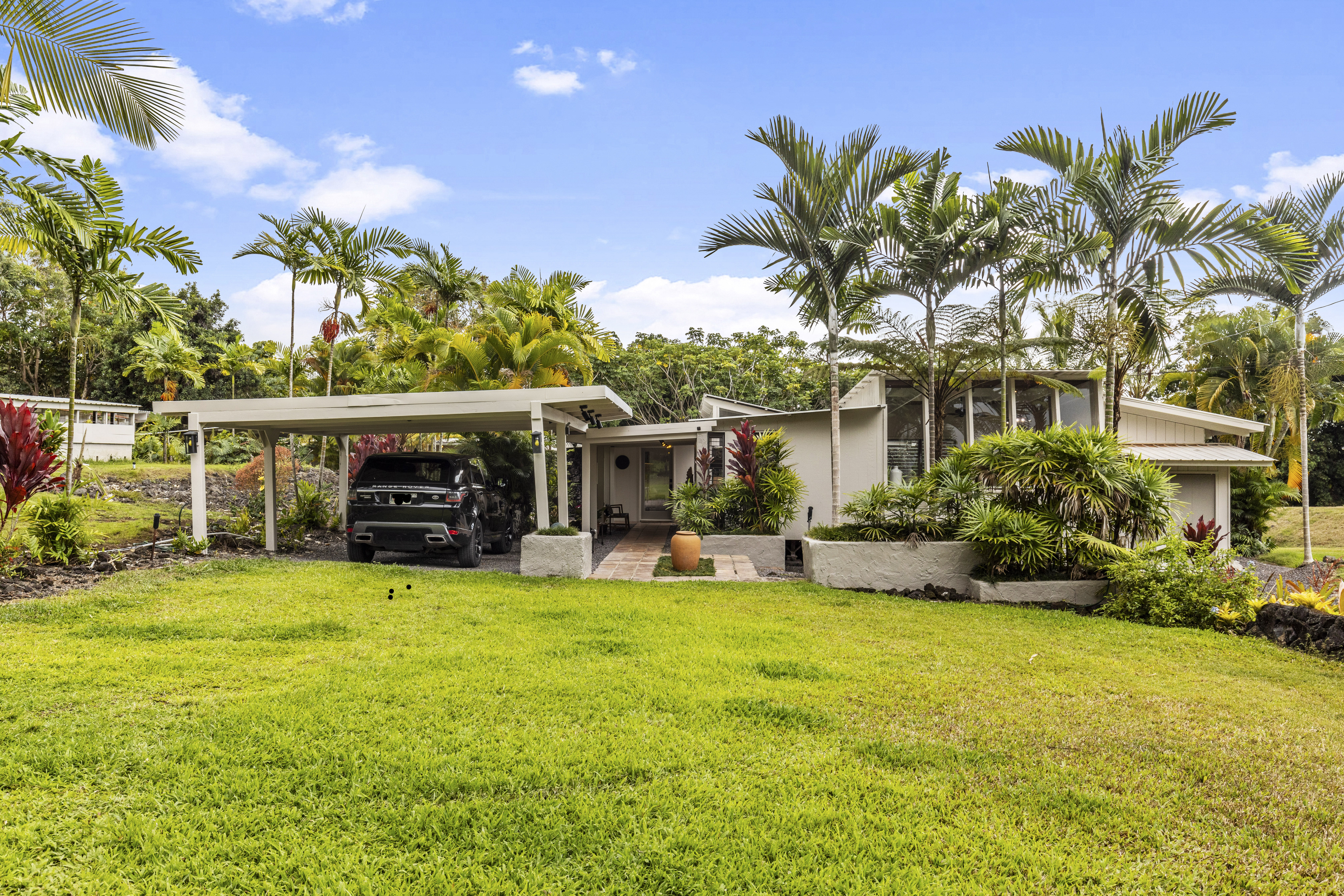 83-5369 Manako Road Captain Cook, HI 96704 - Photo 2 of 30 a view of a house with swimming pool and sitting area