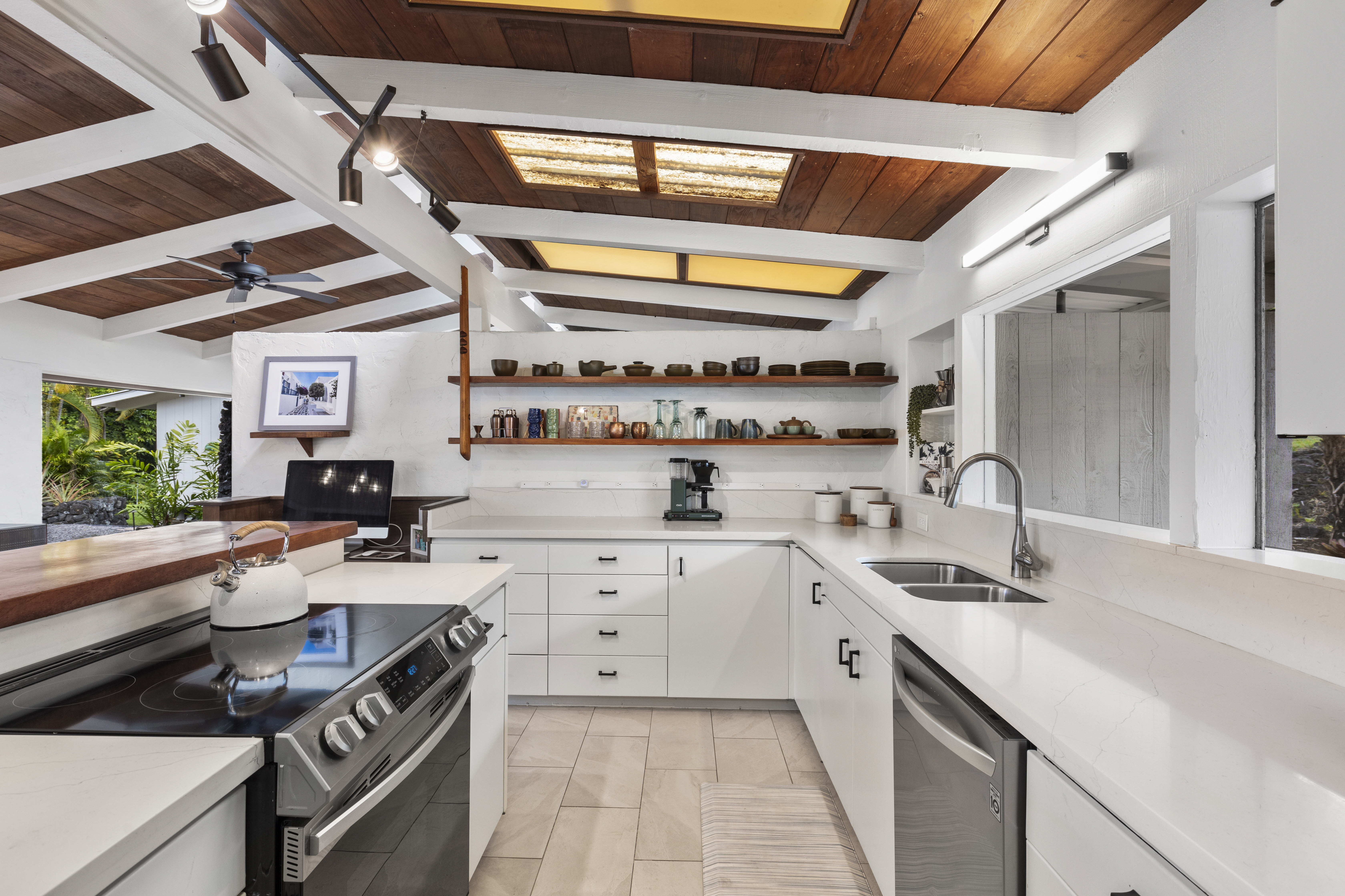 83-5369 Manako Road Captain Cook, HI 96704 - Photo 10 of 30 a kitchen with a sink appliances cabinets and a window