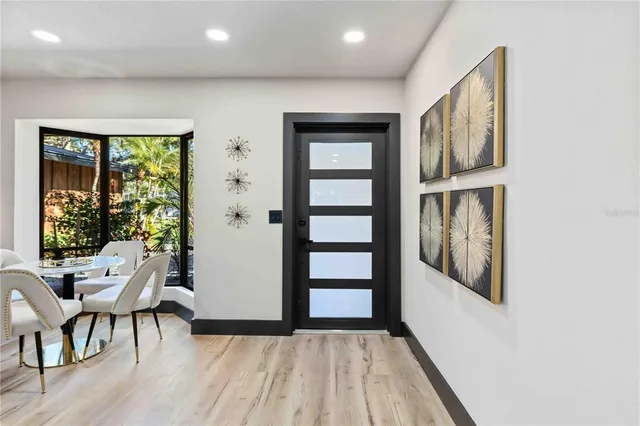 a living room with furniture a clock and a rug
