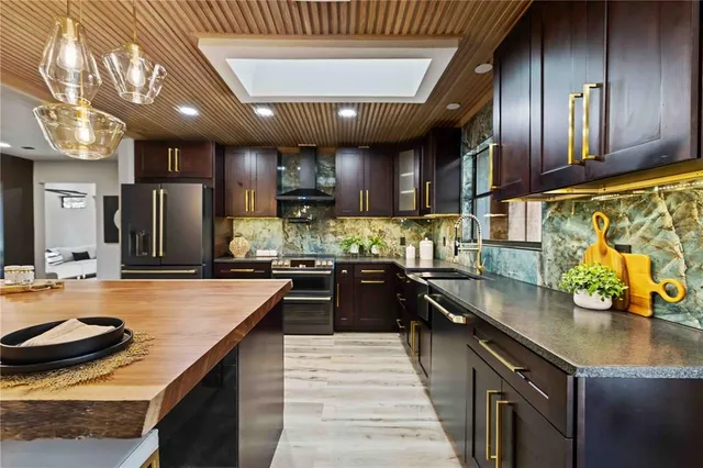 a living room with furniture a chandelier and a large window