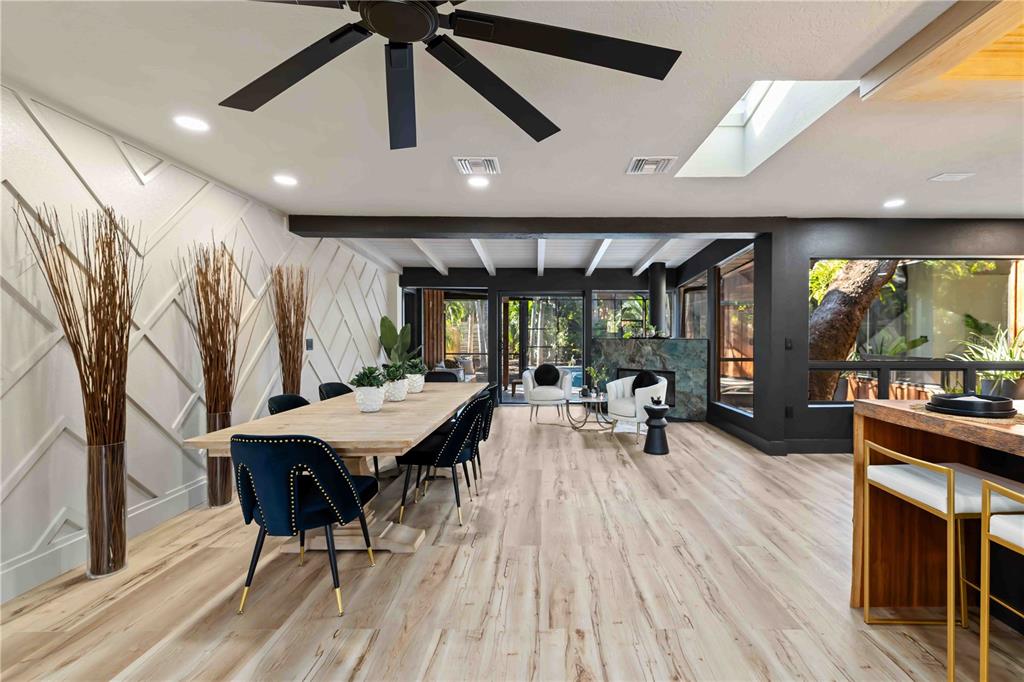 4534 Banan Place Siesta Key, FL 34242 - Photo 16 of 77 a kitchen with stainless steel appliances kitchen island granite countertop a table chairs in it and wooden floors