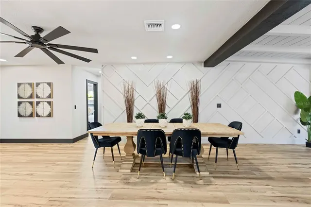a bedroom with two beds and a potted plant