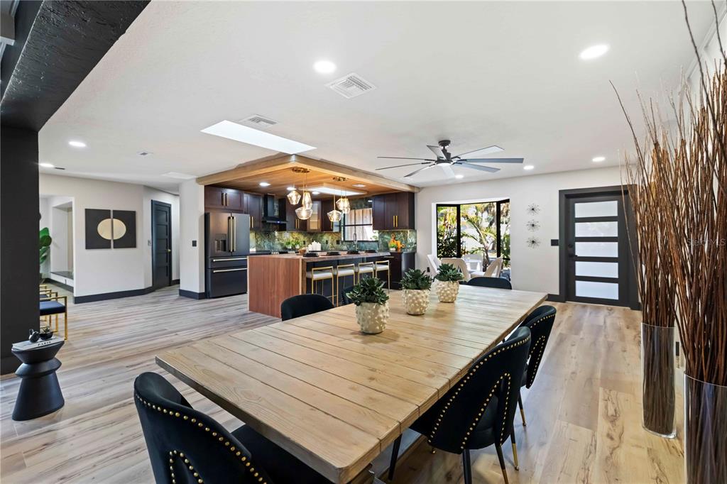 4534 Banan Place Siesta Key, FL 34242 - Photo 18 of 77 an open kitchen with dining table and wooden floor