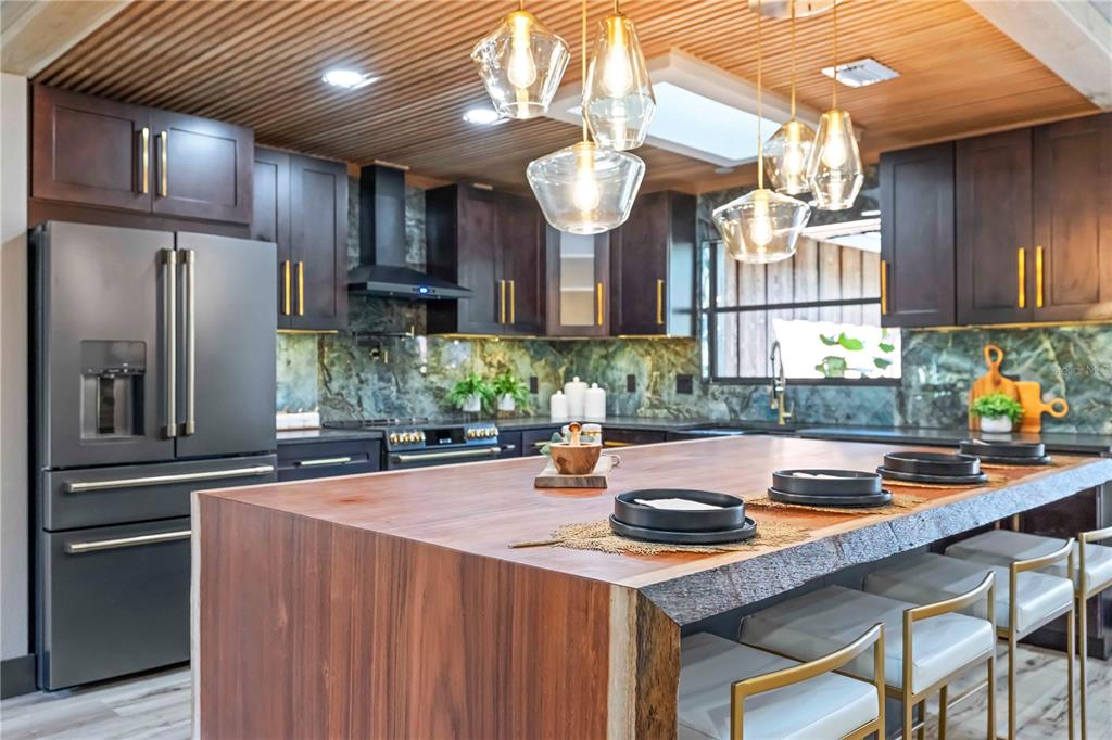 4534 Banan Place Siesta Key, FL 34242 - Photo 2 of 77 a kitchen with stainless steel appliances granite countertop a sink a stove and a refrigerator