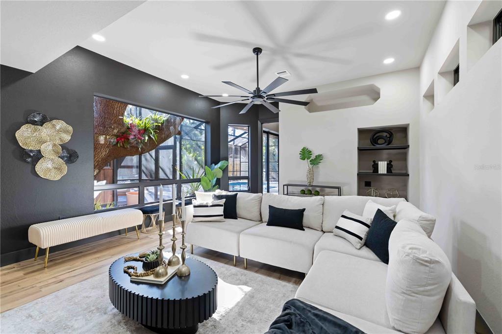 4534 Banan Place Siesta Key, FL 34242 - Photo 28 of 77 a living room with furniture a chandelier and a large window