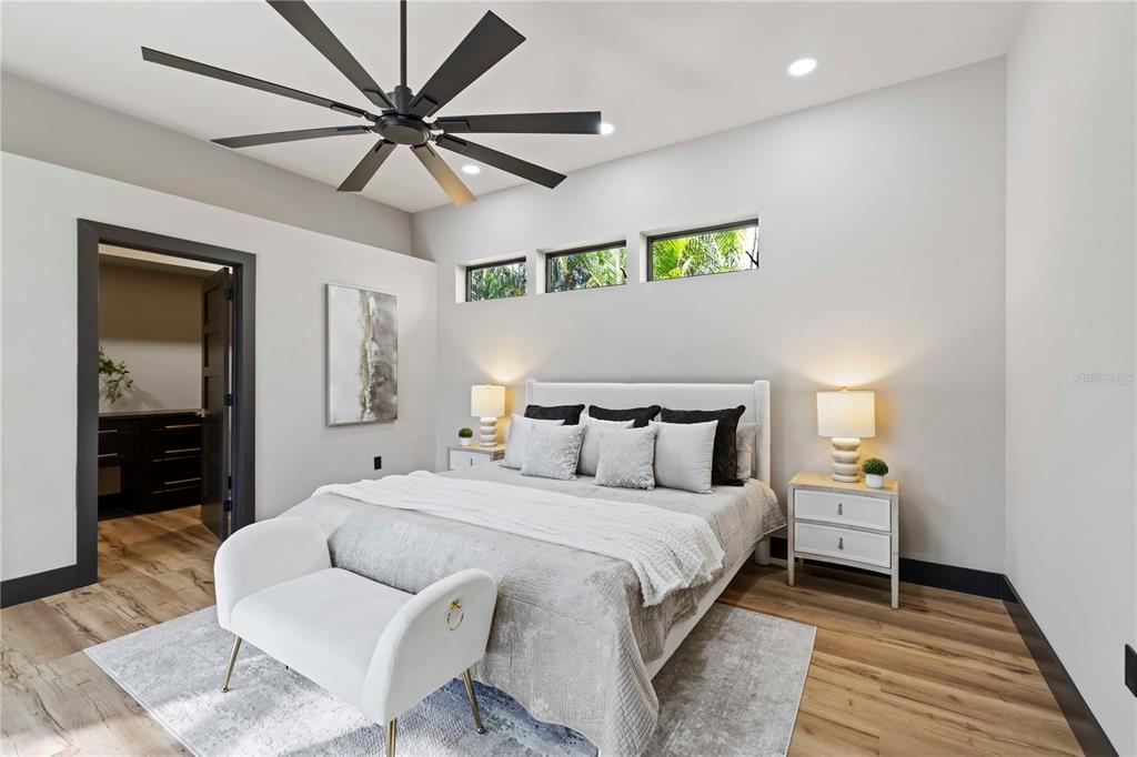 4534 Banan Place Siesta Key, FL 34242 - Photo 32 of 77 a bedroom with a bed and a chandelier