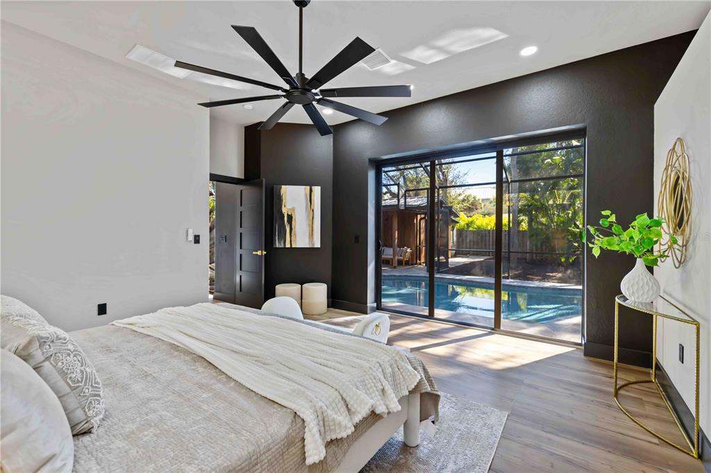 4534 Banan Place Siesta Key, FL 34242 - Photo 34 of 77 a bedroom with a large bed and a large window