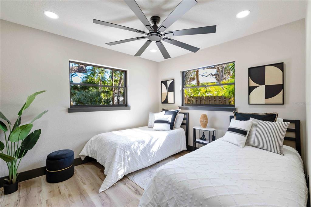 4534 Banan Place Siesta Key, FL 34242 - Photo 38 of 77 a bedroom with two beds and a potted plant