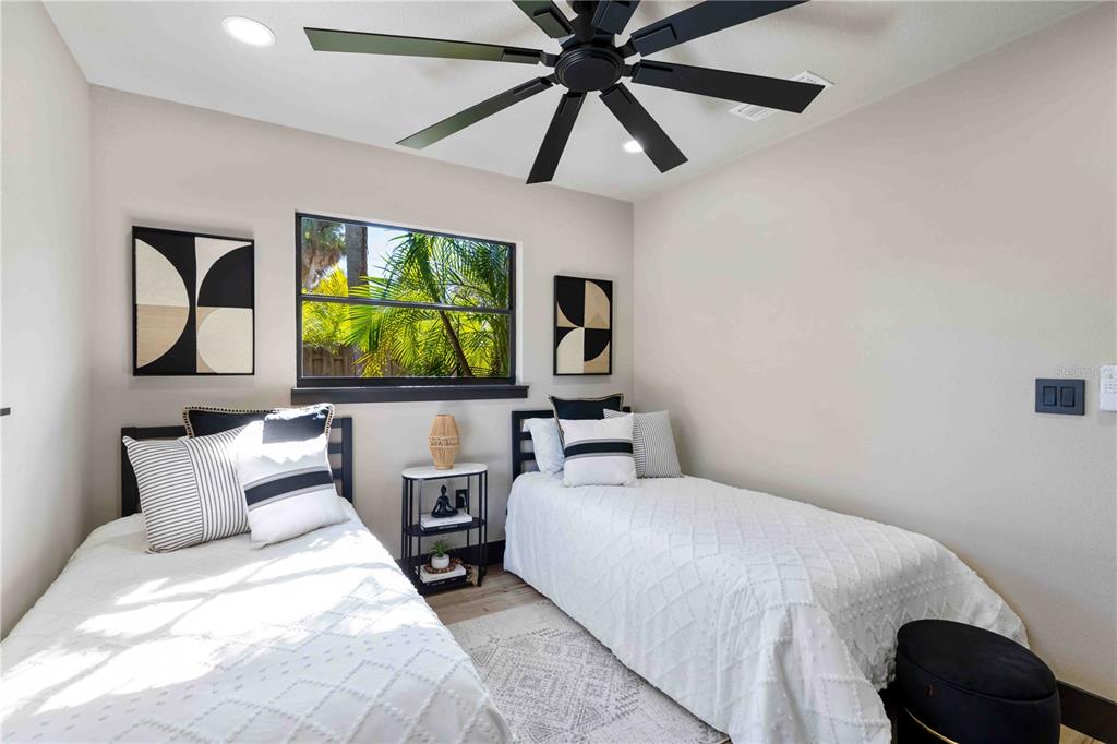 4534 Banan Place Siesta Key, FL 34242 - Photo 39 of 77 a bedroom with a bed and a large window