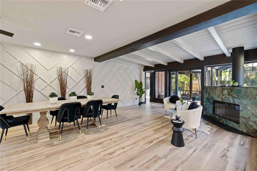 4534 Banan Place Siesta Key, FL 34242 - Photo 4 of 77 a living room with furniture a wooden floor and a fireplace