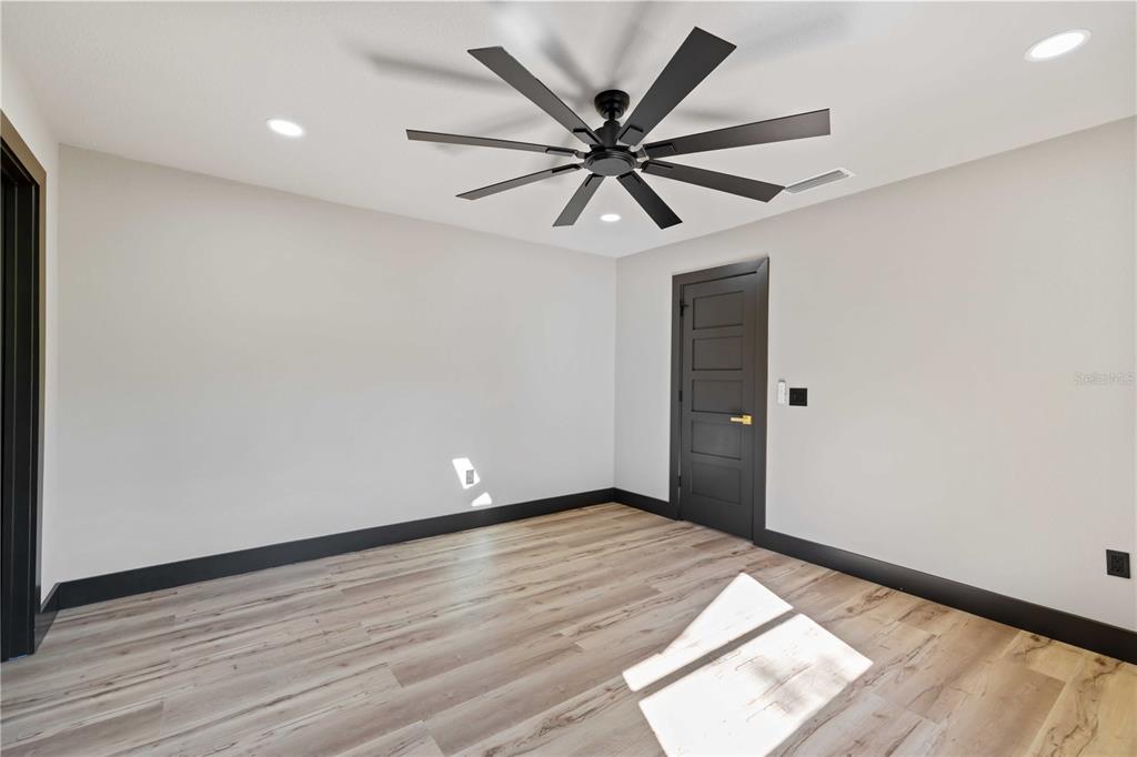 4534 Banan Place Siesta Key, FL 34242 - Photo 50 of 77 wooden floor in an empty room with a window