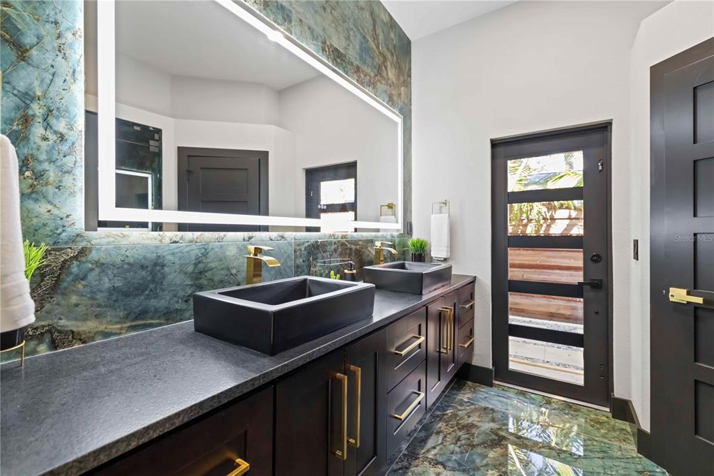 4534 Banan Place Siesta Key, FL 34242 - Photo 7 of 77 a kitchen with kitchen island granite countertop a sink and a stove