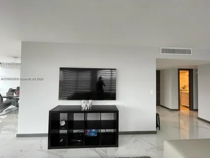 a living room with fireplace furniture and a floor to ceiling window