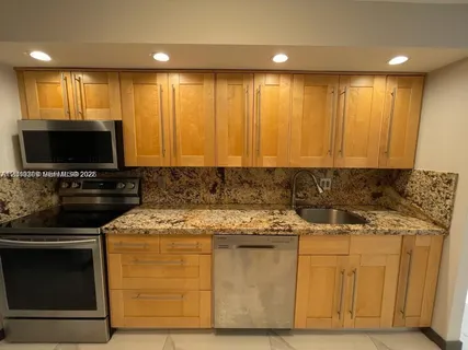 a large bathroom with a granite countertop sink and a large mirror