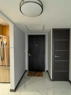a view of hallway with walk in closet and window