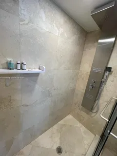 a bathroom with a bathtub and a shower