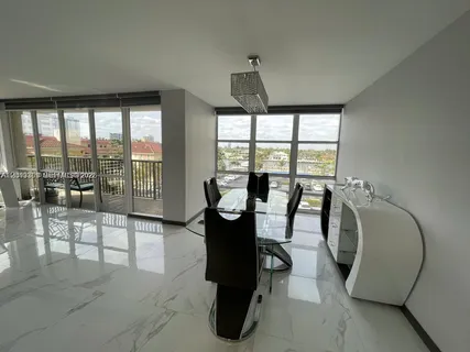 a living room with furniture and large windows