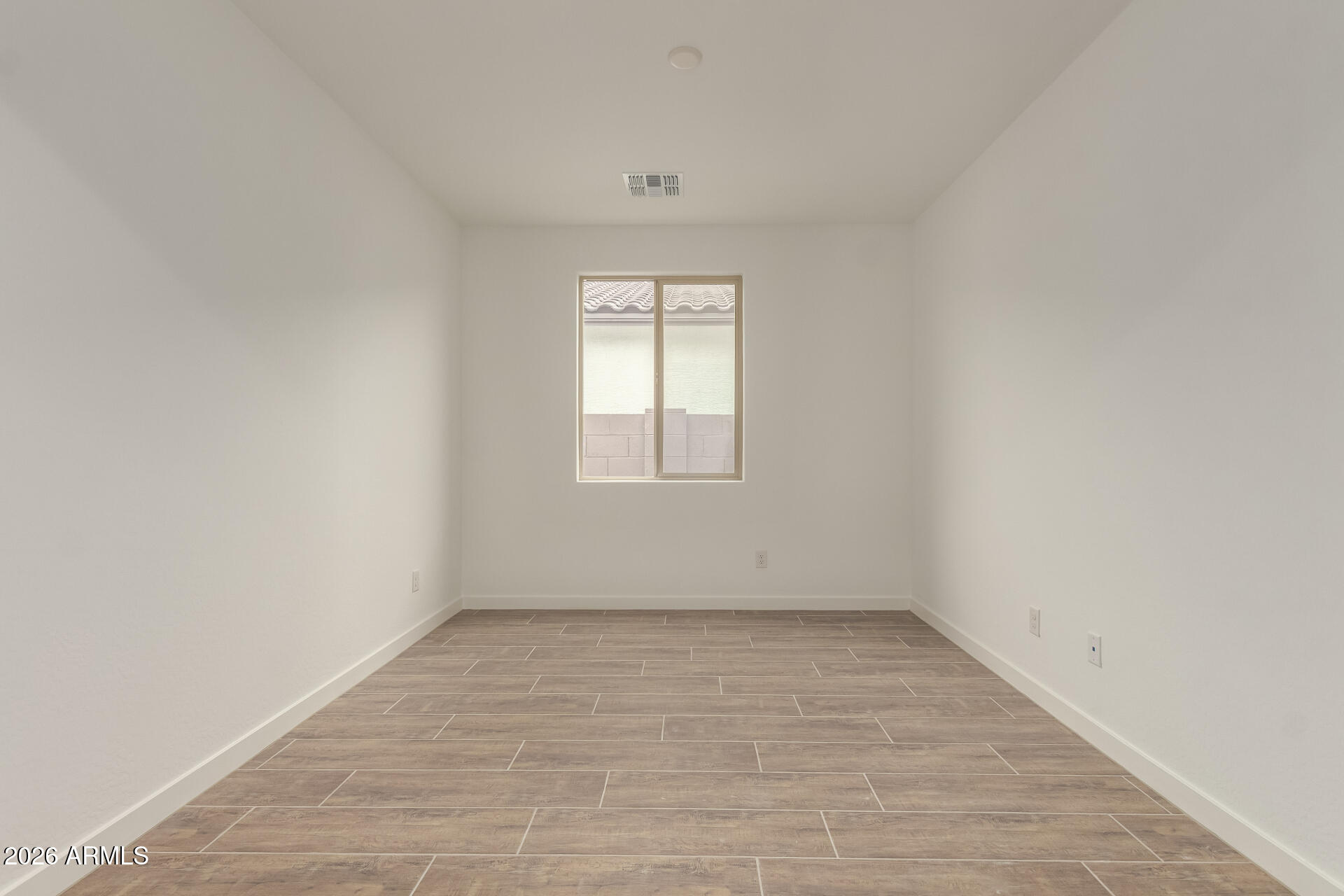 8030 West Granada Road Phoenix, AZ 85035 - Photo 16 of 36 an empty room with a window