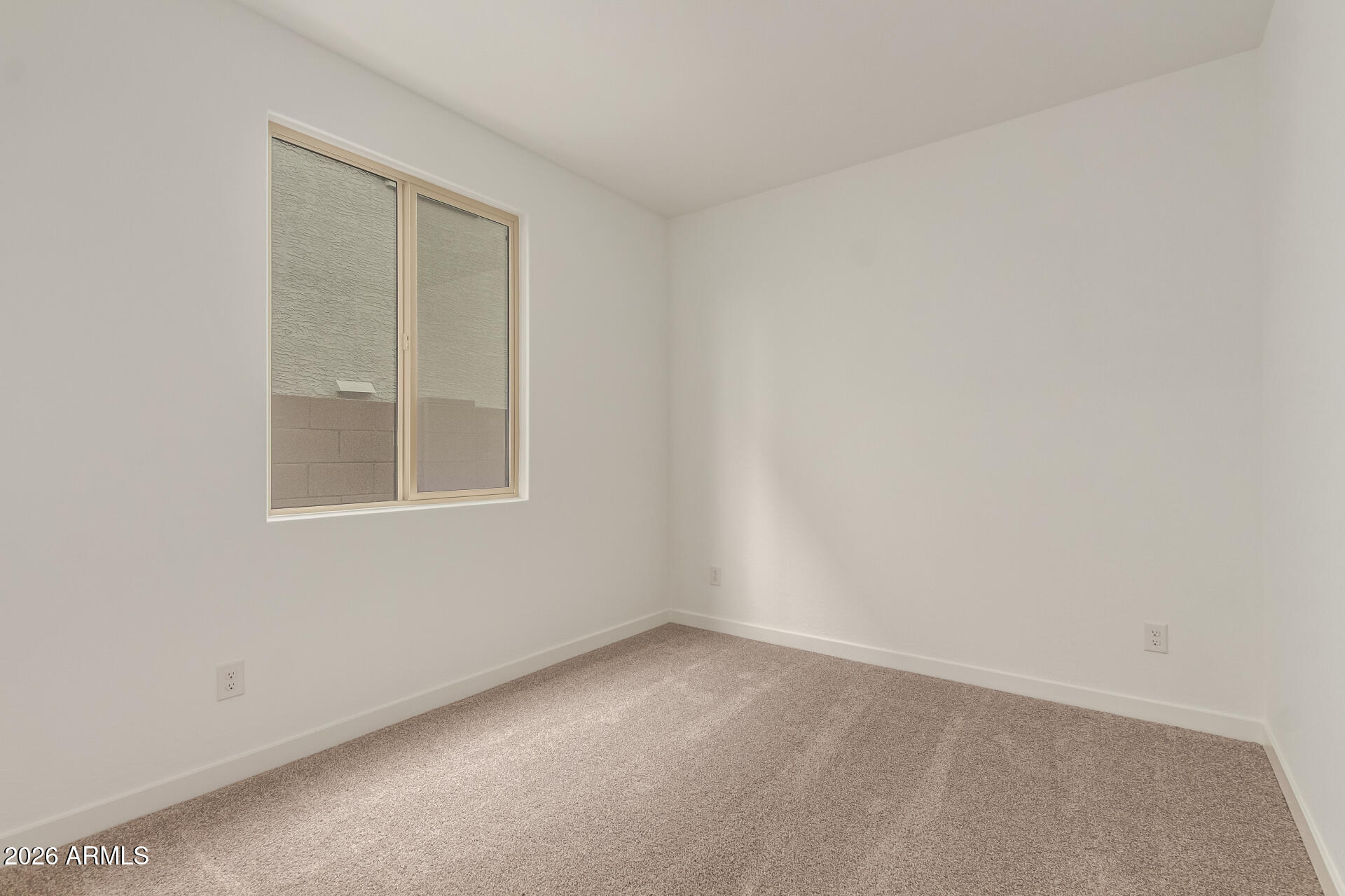 8030 West Granada Road Phoenix, AZ 85035 - Photo 18 of 36 an empty room with a window