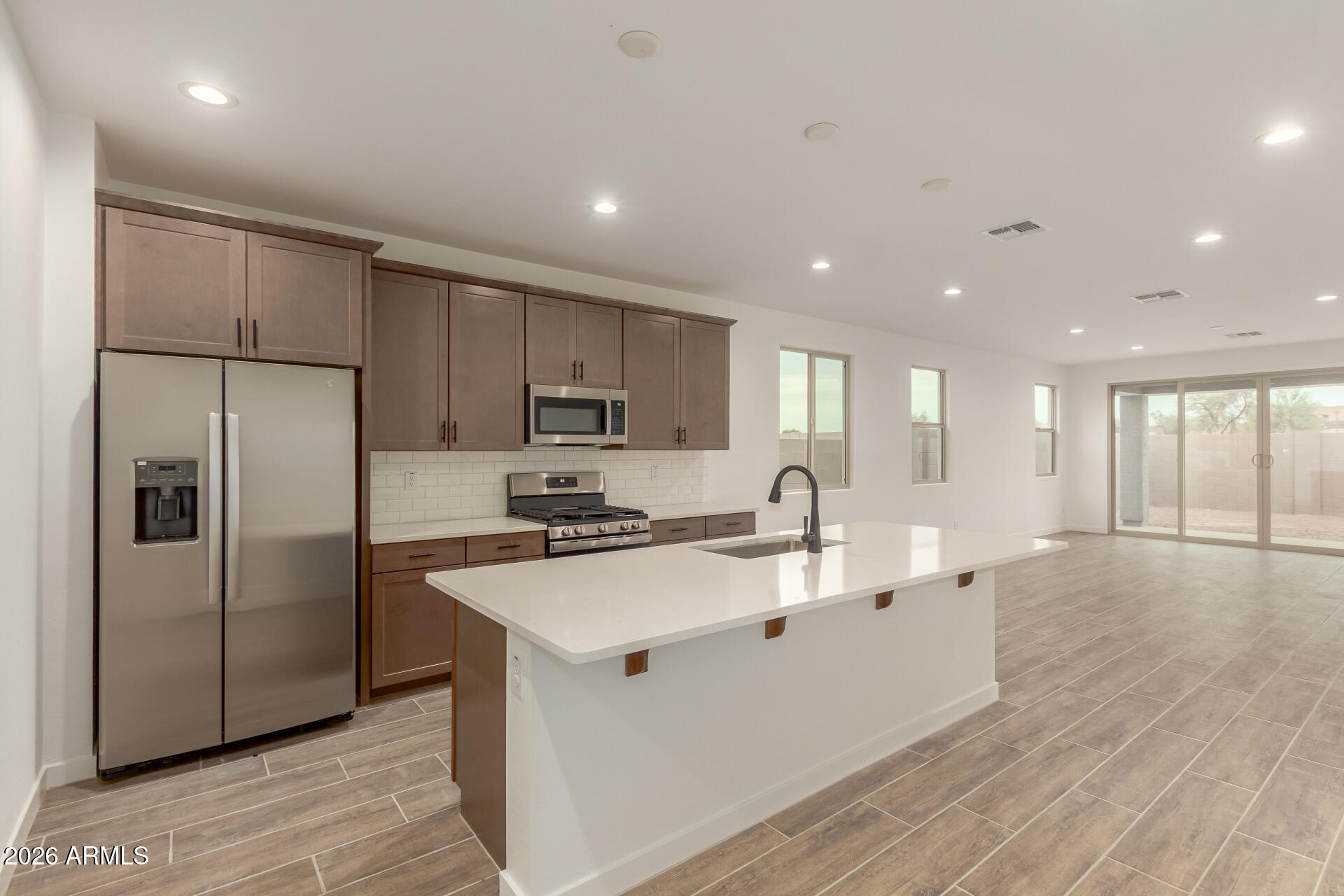 8030 West Granada Road Phoenix, AZ 85035 - Photo 2 of 36 a kitchen with stainless steel appliances granite countertop a refrigerator a sink a stove and white cabinets with wooden floor