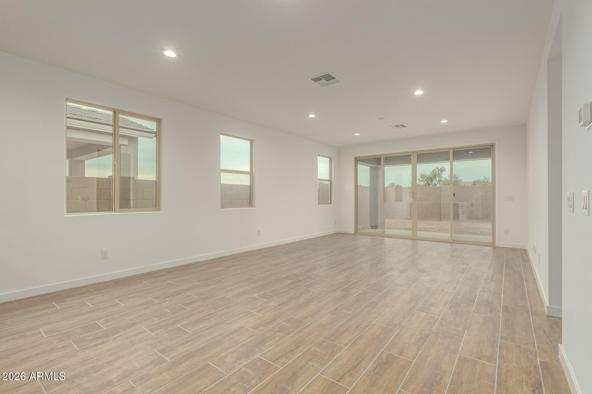 8030 West Granada Road Phoenix, AZ 85035 - Photo 3 of 36 an empty room with wooden floor and windows