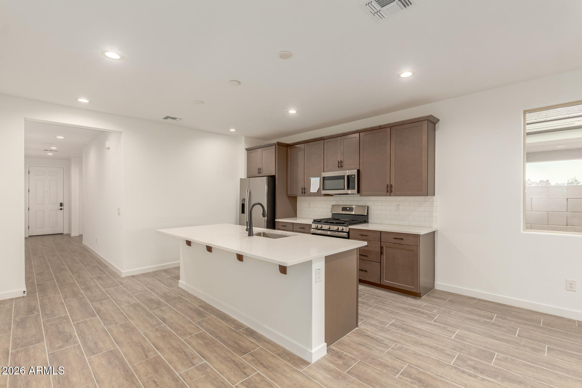 8030 West Granada Road Phoenix, AZ 85035 - Photo 6 of 36 a kitchen with stainless steel appliances a sink stove and wooden floor