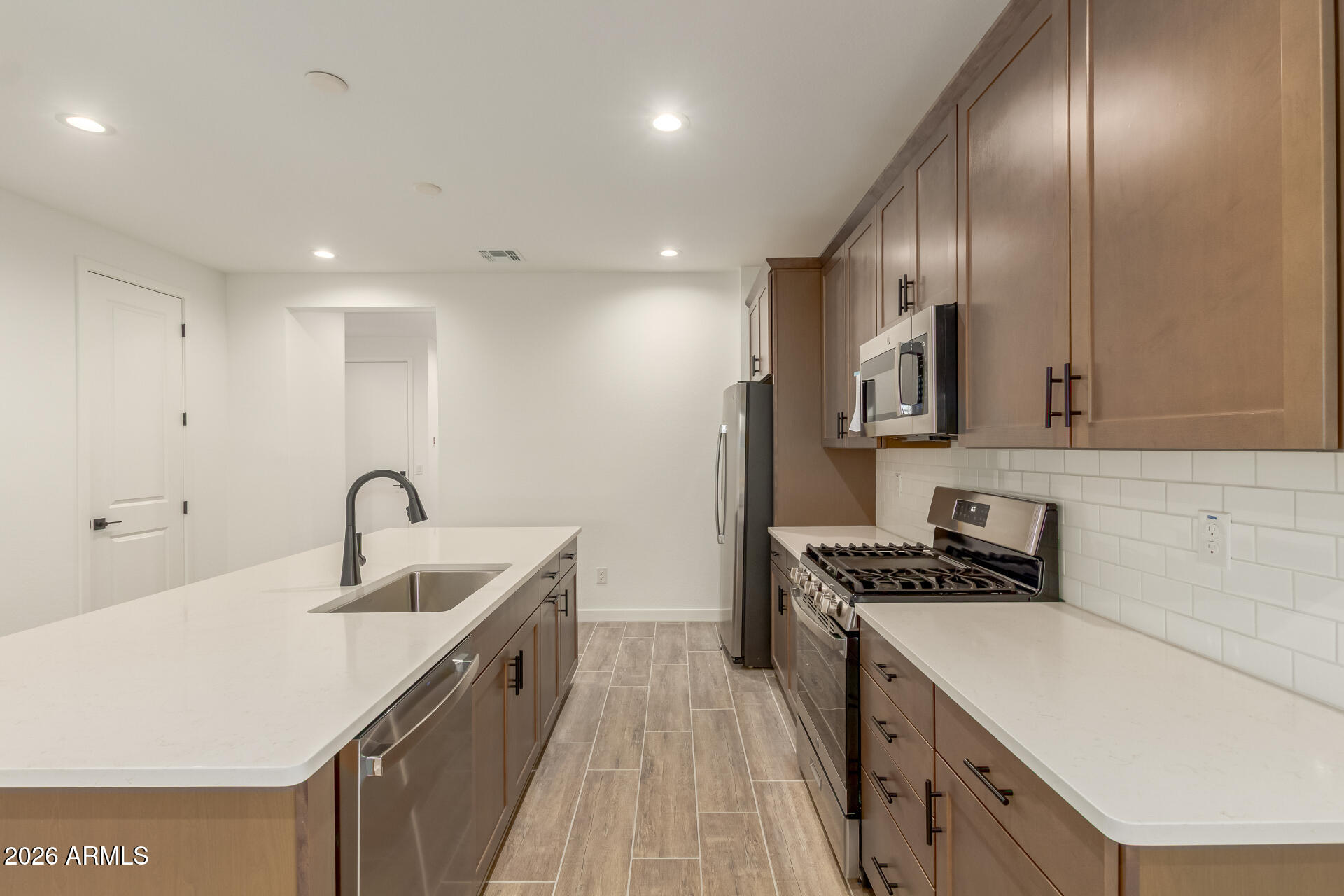 8030 West Granada Road Phoenix, AZ 85035 - Photo 7 of 36 a kitchen with stainless steel appliances granite countertop a sink a stove and a refrigerator