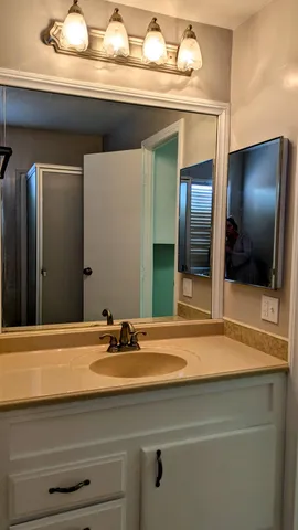 a bathroom with a sink and a mirror