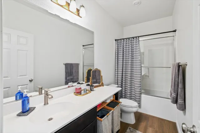 a bathroom with a sink a toilet and a mirror