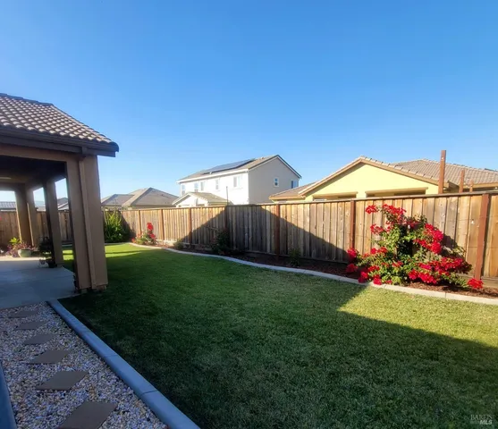 a view of a house with a small yard and plants