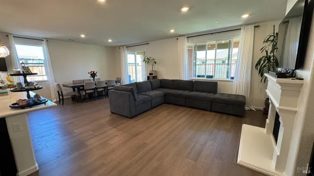 a living room with furniture flat screen tv and a window