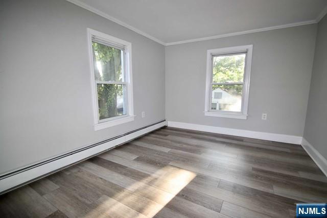323 Maple Avenue, Unit 2 Oradell, NJ 07649 - Photo 3 of 8 an empty room with wooden floor and windows