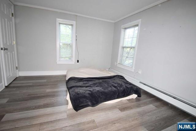 323 Maple Avenue, Unit 2 Oradell, NJ 07649 - Photo 4 of 8 a living room with a bed and a window