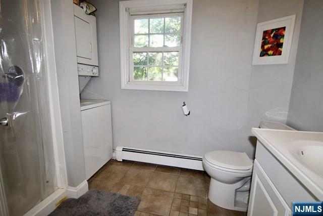 323 Maple Avenue, Unit 2 Oradell, NJ 07649 - Photo 6 of 8 a white toilet sitting next to a bathroom sink and tub